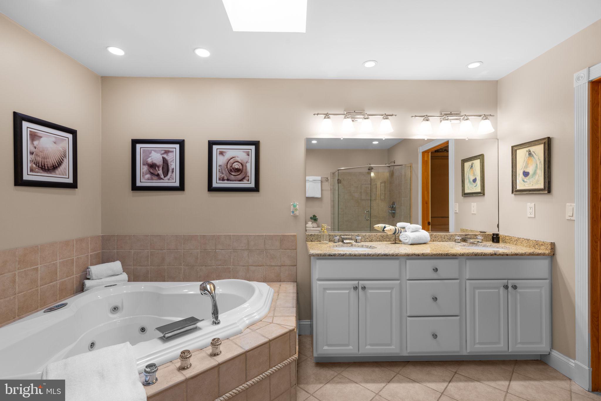 7674 Pine Knob Road Pasadena, MD 21122 - Photo 31 of 59 a bathroom with a tub sink and mirror