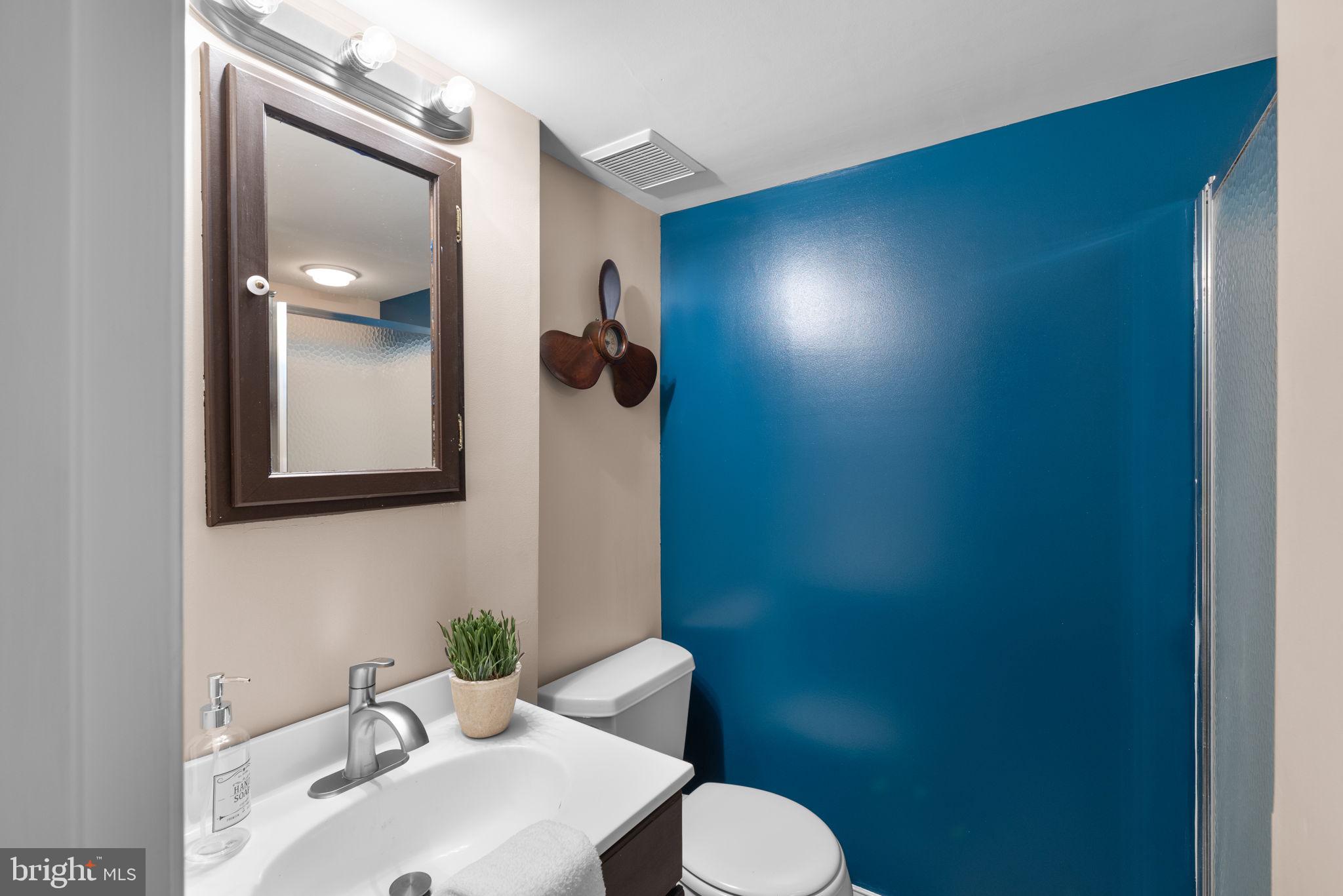 7674 Pine Knob Road Pasadena, MD 21122 - Photo 36 of 59 a bathroom with a toilet sink and mirror