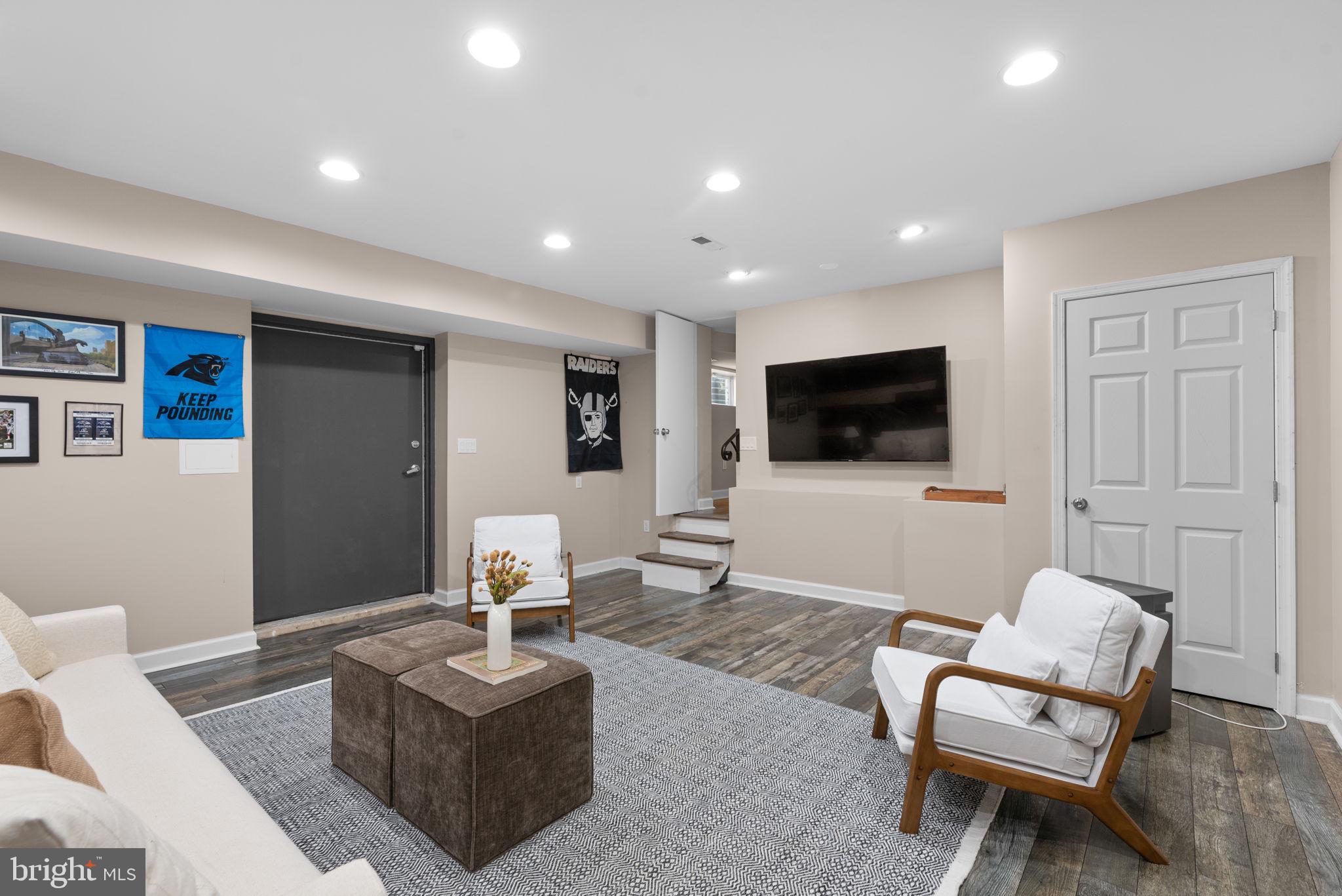 7674 Pine Knob Road Pasadena, MD 21122 - Photo 38 of 59 a living room with furniture and a flat screen tv