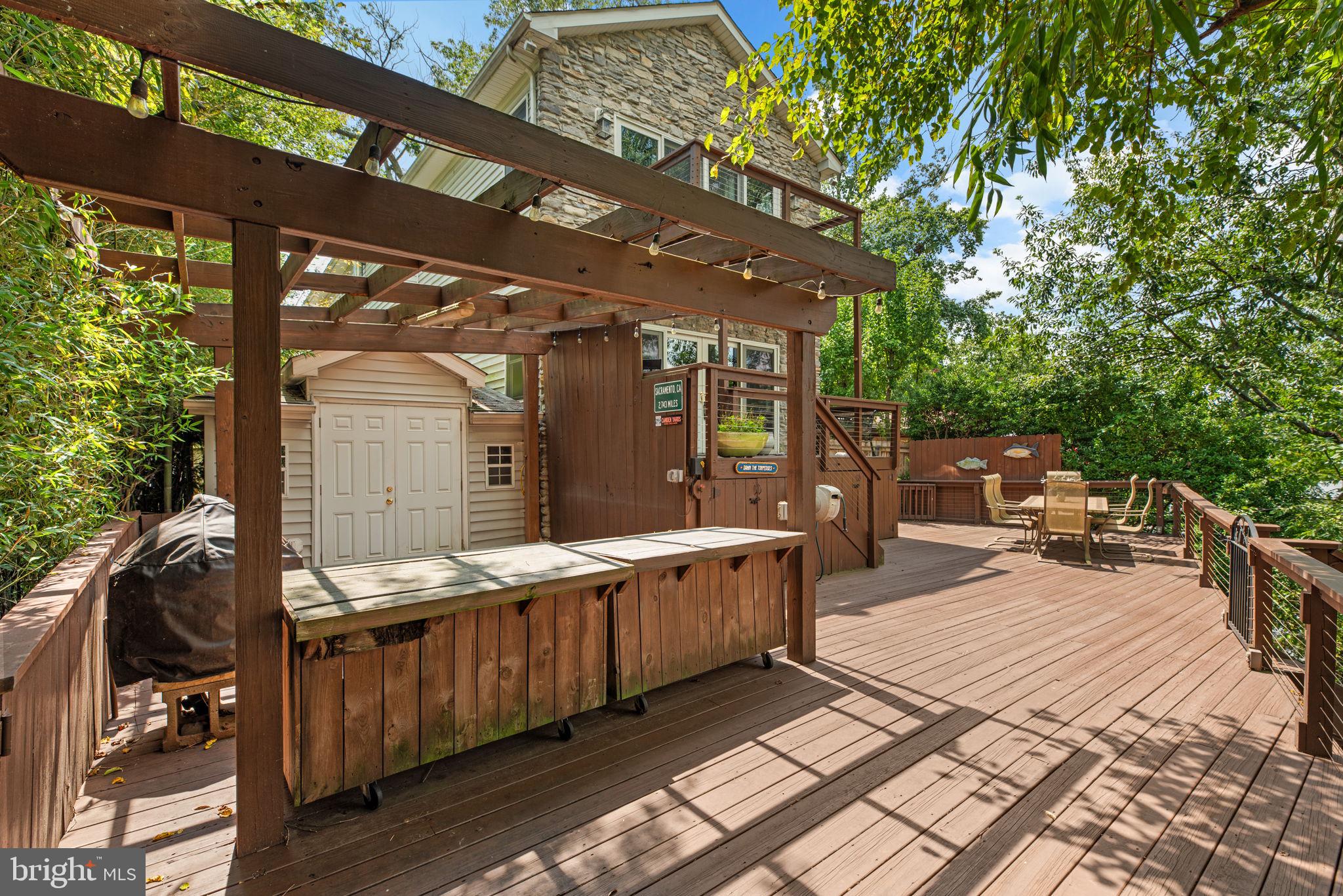 7674 Pine Knob Road Pasadena, MD 21122 - Photo 40 of 59 a view of a patio with table and chairs wooden floor and fence