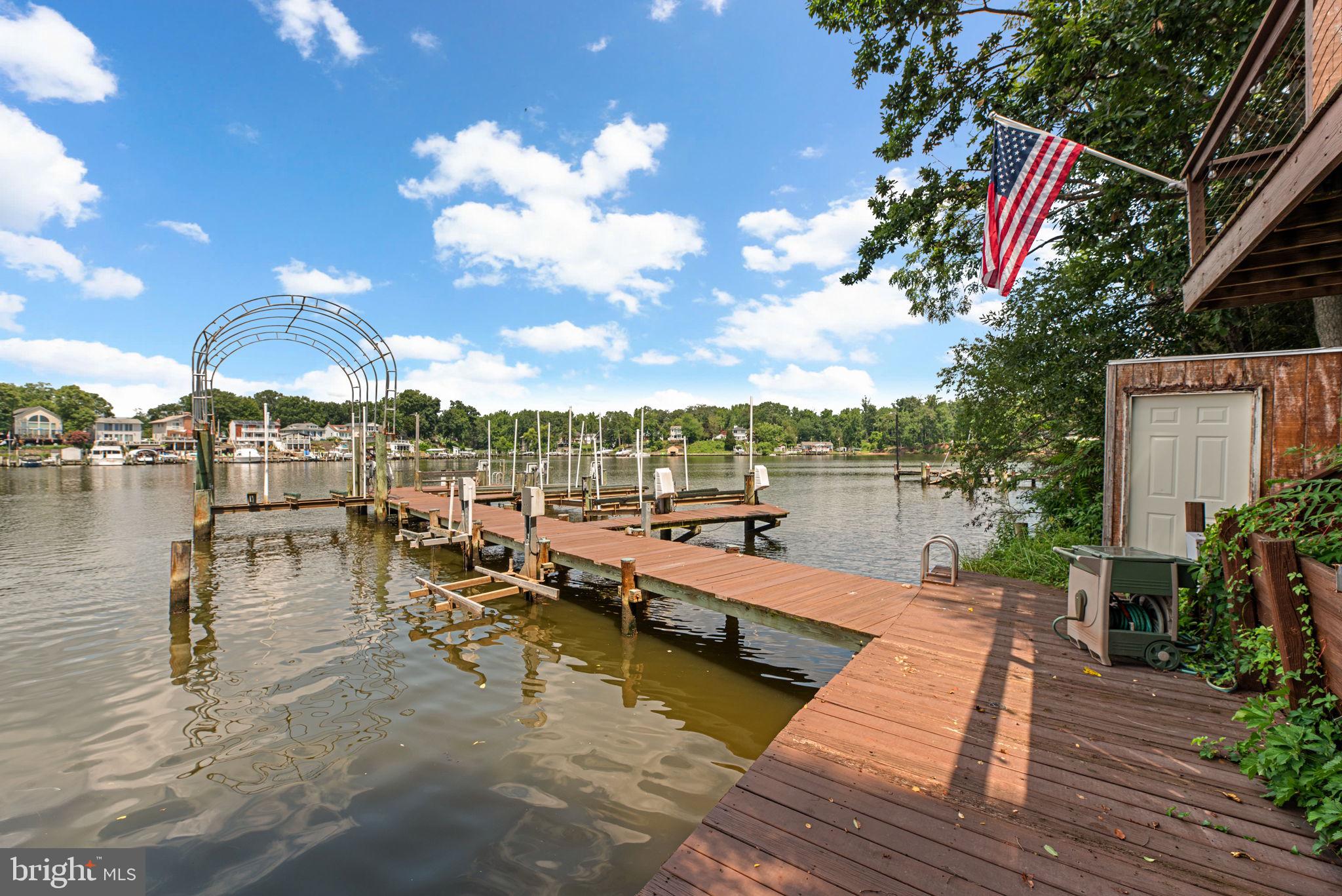 7674 Pine Knob Road Pasadena, MD 21122 - Photo 45 of 59 a view of a lake with couches and tables