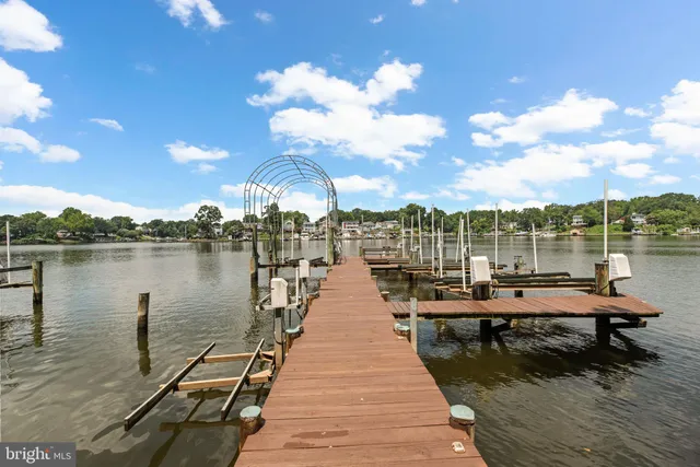 an aerial view of a house with a yard lake lake and mountain view