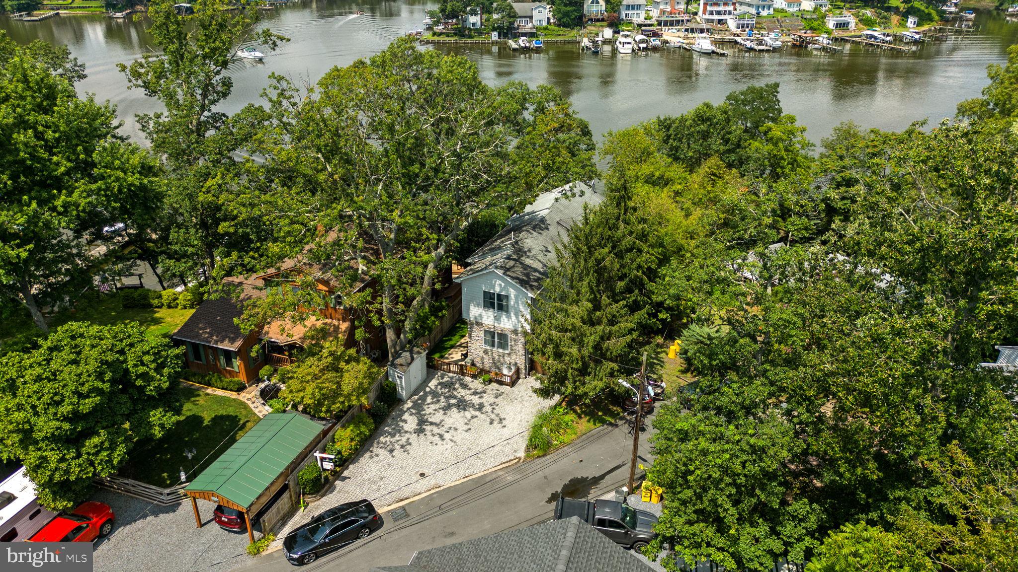 7674 Pine Knob Road Pasadena, MD 21122 - Photo 52 of 59 an aerial view of a house with a yard lake lake and mountain view