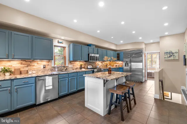 a kitchen with sink a table and chairs