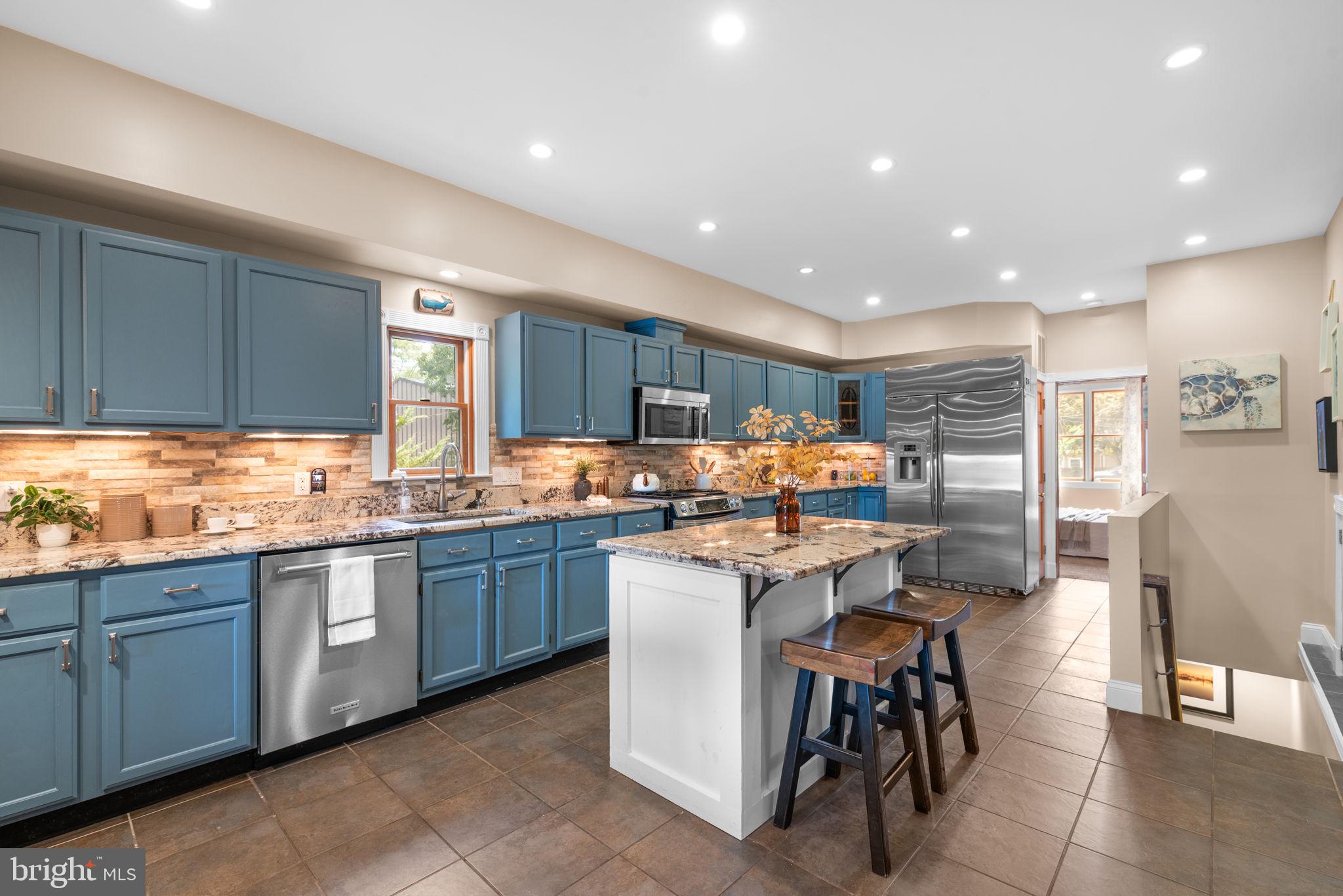7674 Pine Knob Road Pasadena, MD 21122 - Photo 9 of 59 a kitchen with sink a table and chairs