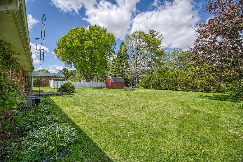 324 Beckenham Road Englewood, OH 45322 - Photo 23 of 26 This spacious backyard offers privacy with a charming shed and mature landscaping.