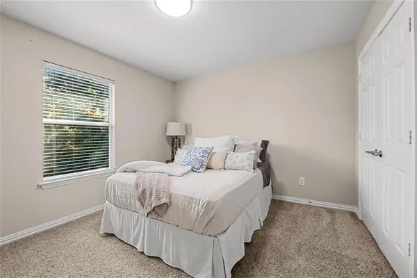 a bedroom with a bed and a window