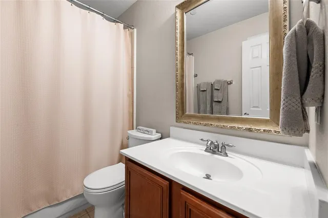 a bathroom with a sink toilet and mirror