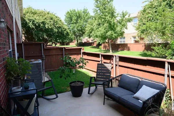 a view of a patio with couches chairs and potted plants