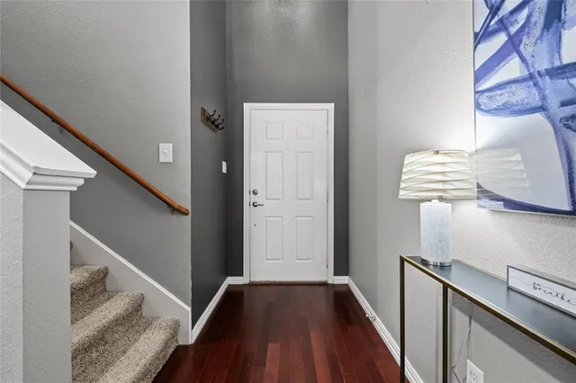 a view of hallway with wooden floor