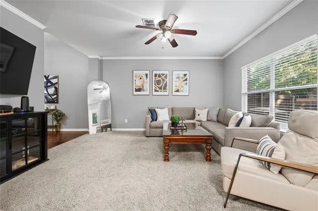 a living room with furniture a flat screen tv and a large window