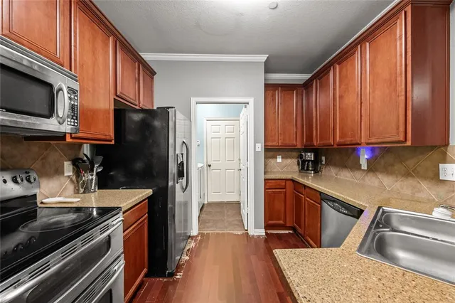 a kitchen with a refrigerator stove and sink