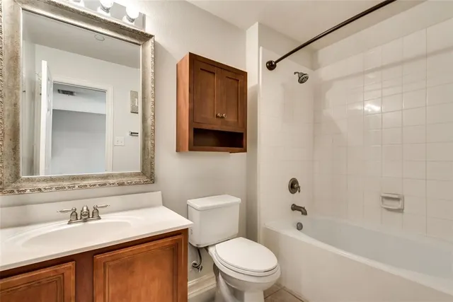 a bathroom with a sink toilet vanity and shower