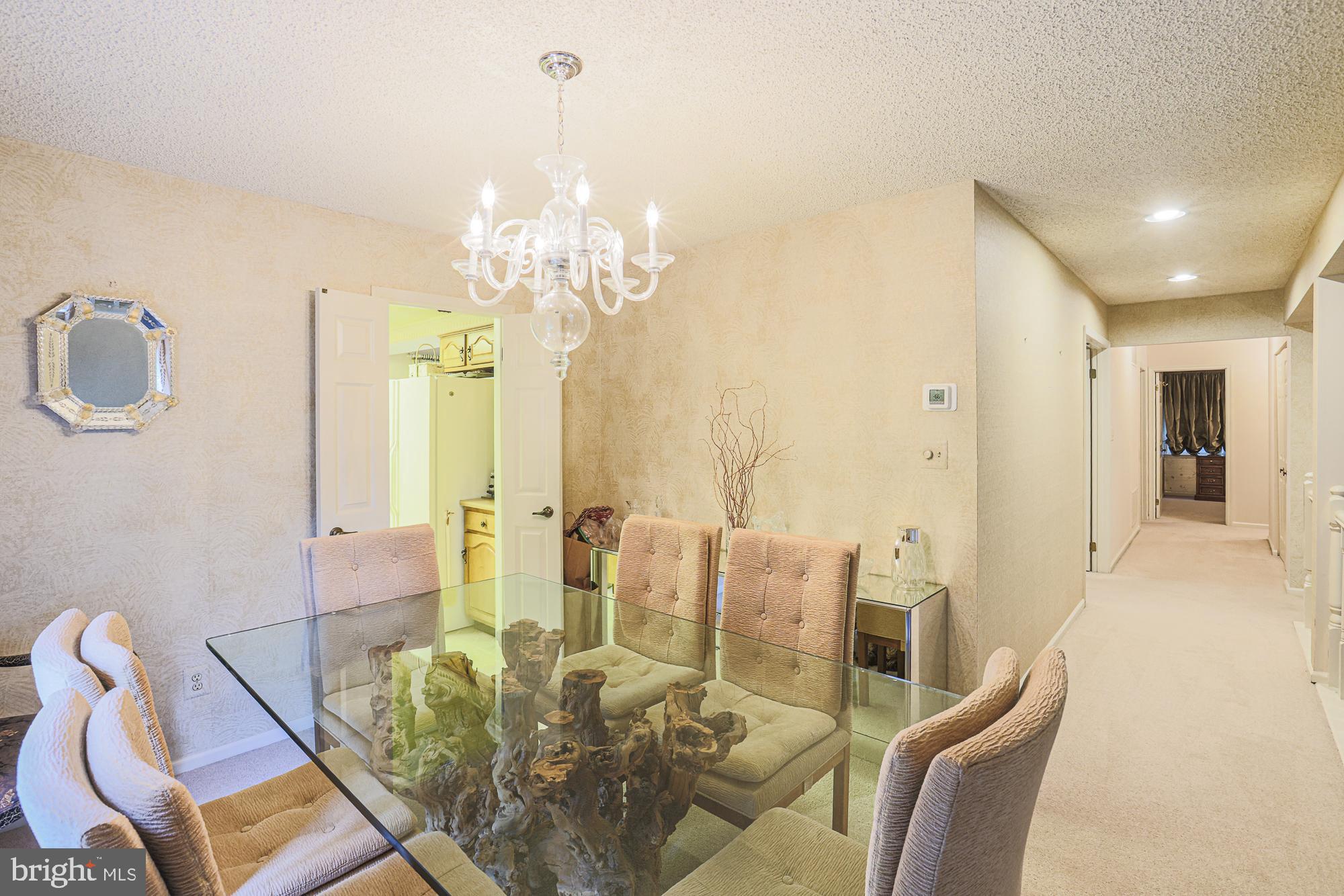 260 Hunters Ridge Road Lutherville-Timonium, MD 21093 - Photo 13 of 48 a view of a dining room with furniture a chandelier and wooden floor