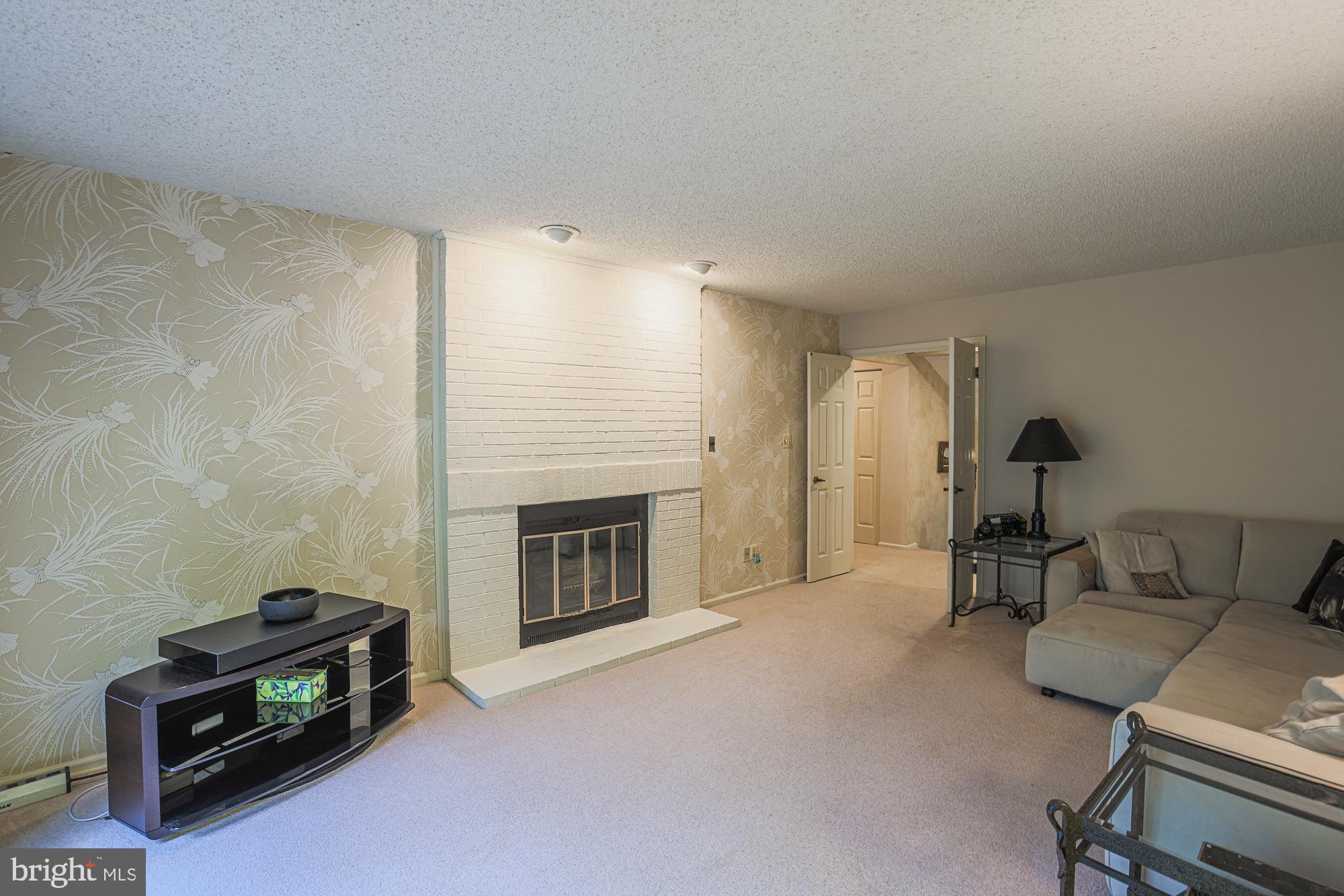 260 Hunters Ridge Road Lutherville-Timonium, MD 21093 - Photo 22 of 48 a living room with furniture and a fireplace