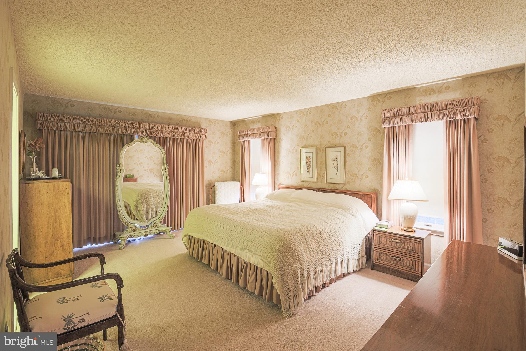 260 Hunters Ridge Road Lutherville-Timonium, MD 21093 - Photo 23 of 48 a spacious bedroom with a bed a mirror and windows