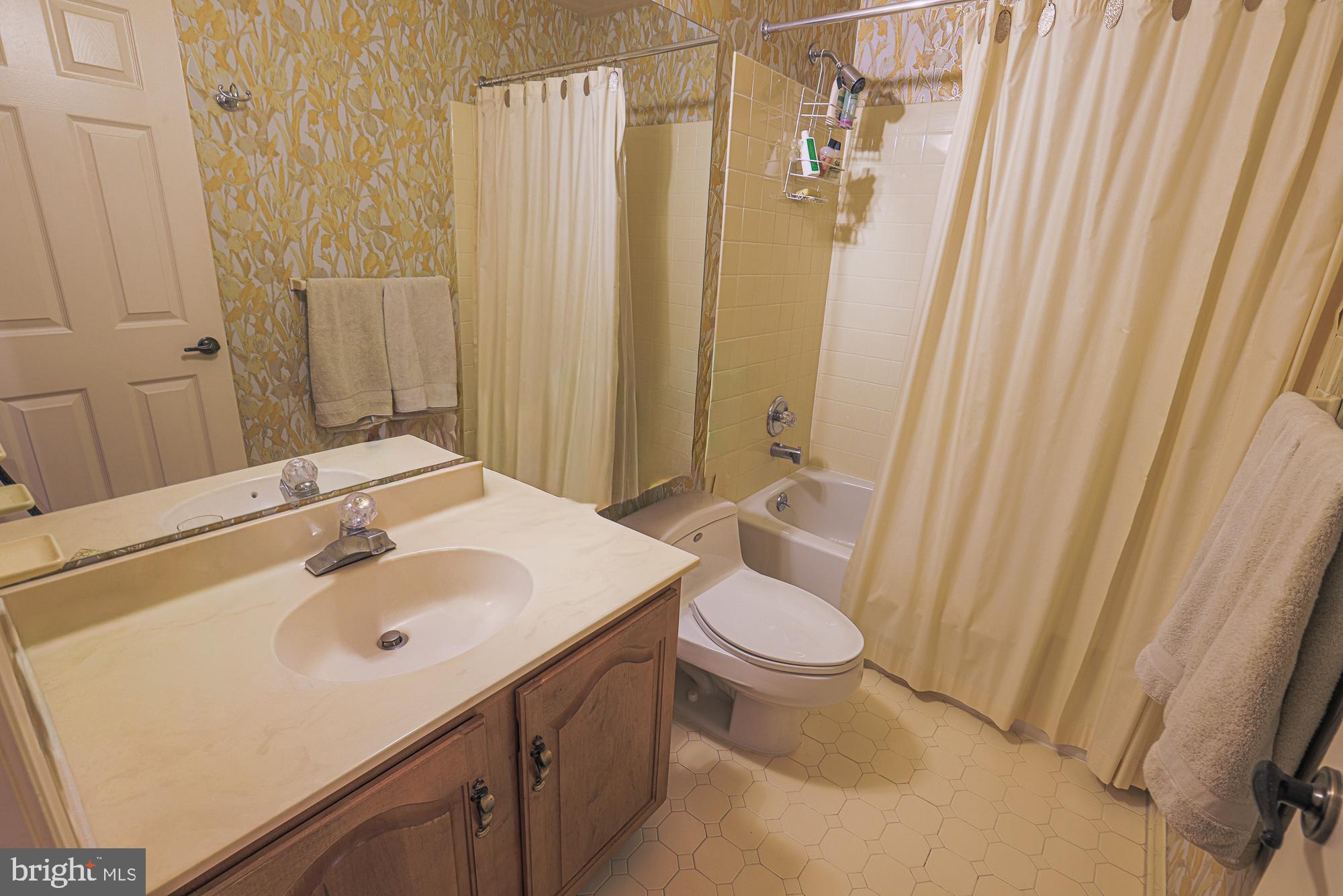 260 Hunters Ridge Road Lutherville-Timonium, MD 21093 - Photo 36 of 48 a bathroom with a sink a toilet and shower curtain