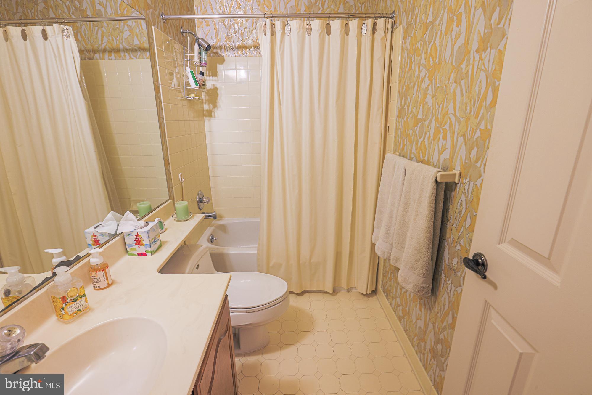 260 Hunters Ridge Road Lutherville-Timonium, MD 21093 - Photo 37 of 48 a bathroom with a sink a toilet and shower curtain