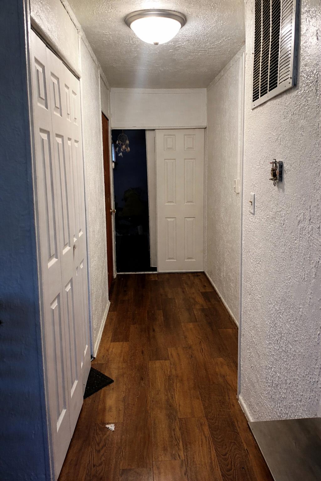 5617 East 13th Place Gary, IN 46403 - Photo 12 of 12 a view of a hallway with wooden floor and staircase
