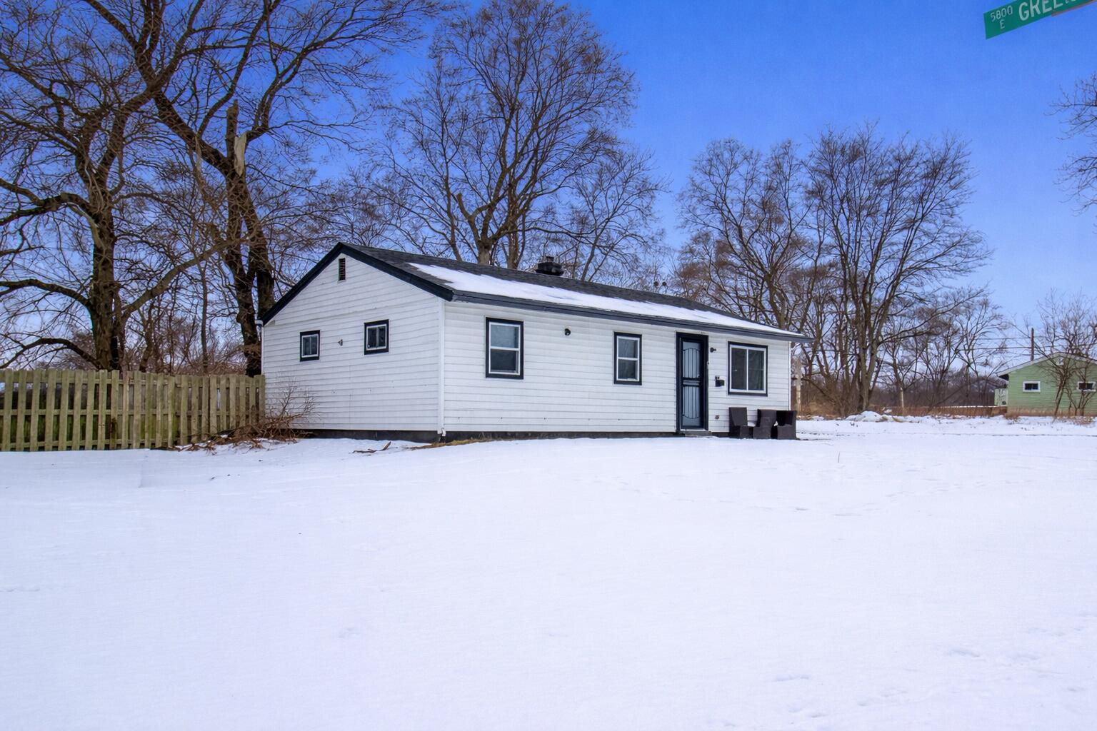 5617 East 13th Place Gary, IN 46403 - Photo 2 of 12 a view of a house with a yard covered in snow