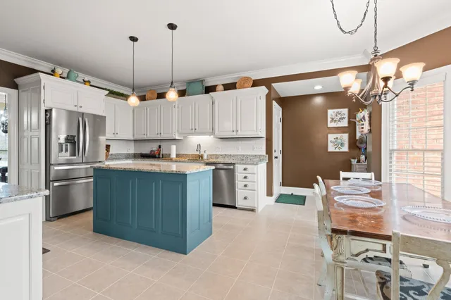a kitchen with stainless steel appliances granite countertop a refrigerator and a stove top oven