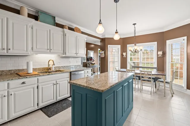 a kitchen with center island table and chairs