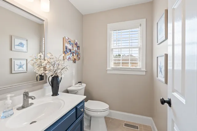 a bathroom with a sink mirror and toilet