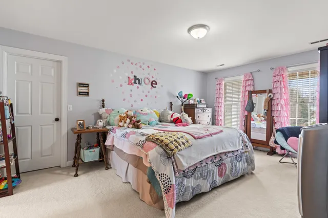 a bathroom with a granite countertop sink mirror vanity and a toilet