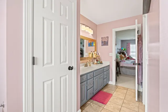 a bedroom with two beds and potted plant