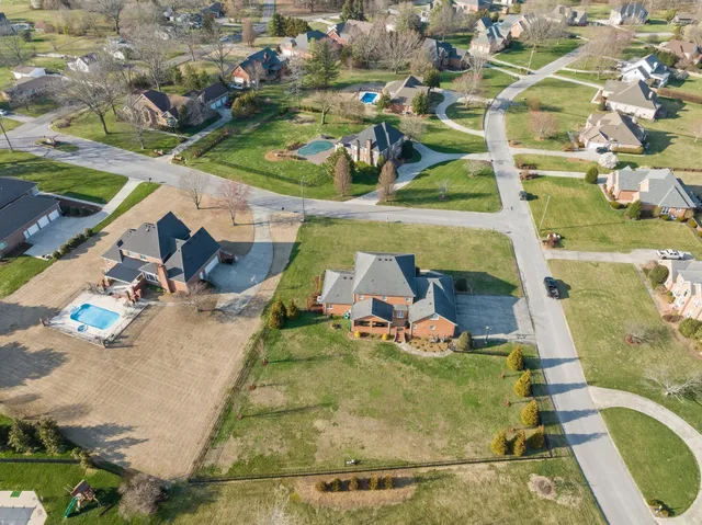 an aerial view of a house with a swimming pool