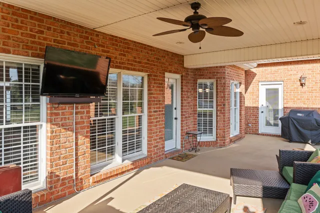 a roof deck with couches and potted plants