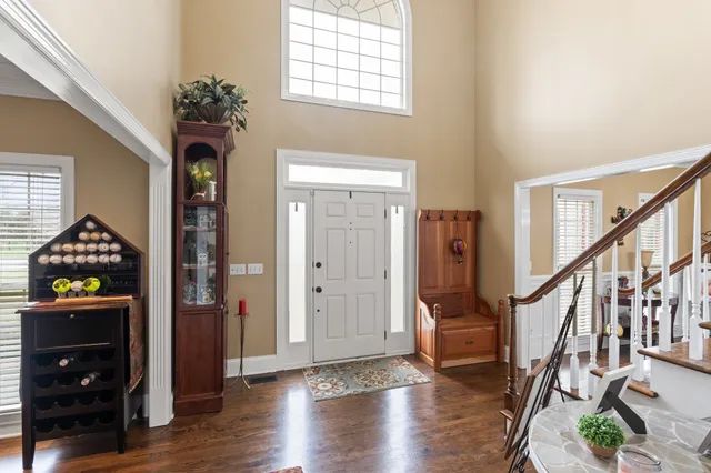 a view of an entryway with wooden floor and staircase