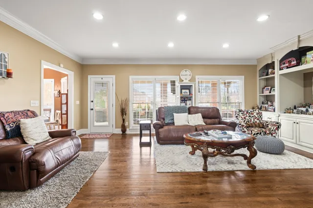 a living room with furniture and wooden floor