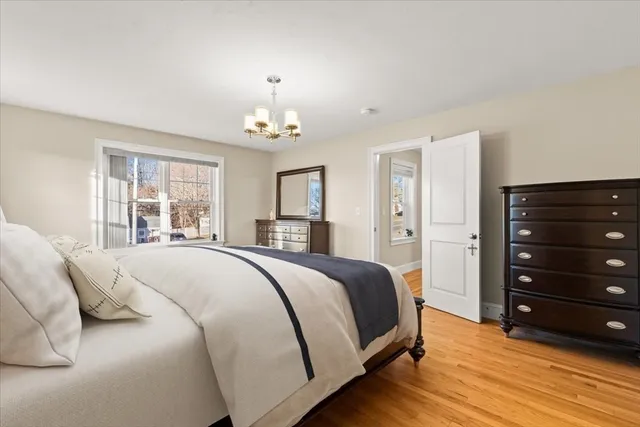 a spacious bedroom with a bed and a dresser