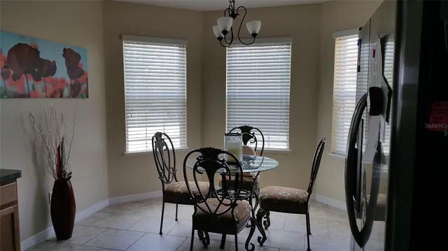 a view of a dining room with furniture and a window