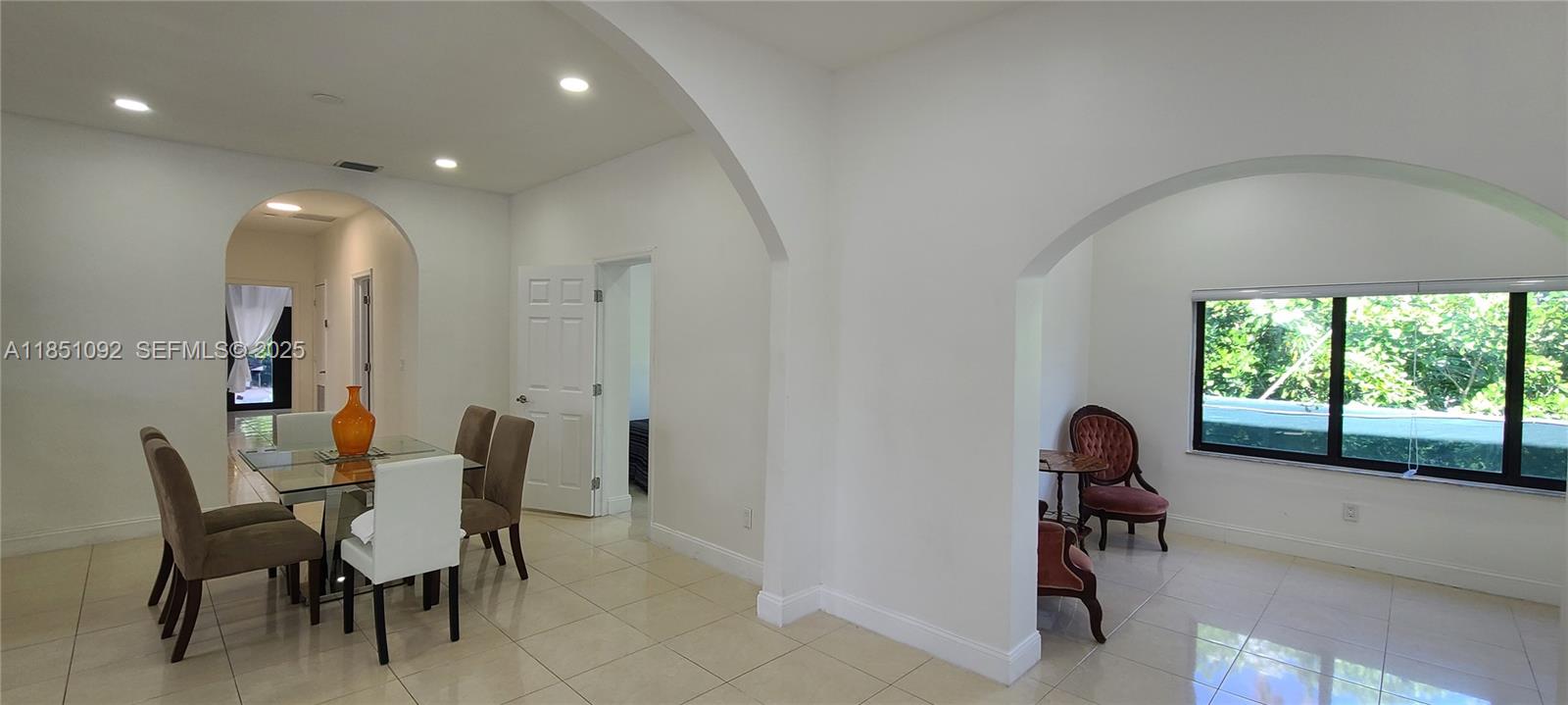 1721 Southwest 24th Terrace Miami, FL 33145 - Photo 18 of 80 a view of a dining room with furniture and a large window