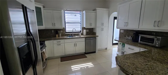 a view of a livingroom with wooden floor and a cabinet