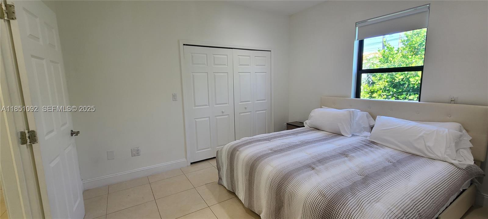 1721 Southwest 24th Terrace Miami, FL 33145 - Photo 33 of 80 a bedroom with a bed and a window