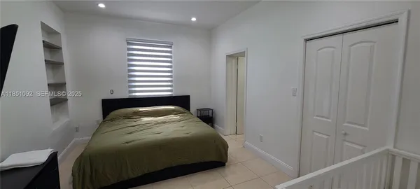a white toilet sitting next to a bathroom sink