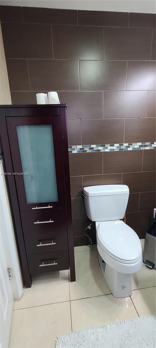 1721 Southwest 24th Terrace Miami, FL 33145 - Photo 53 of 80 a bathroom with a toilet a sink and mirror