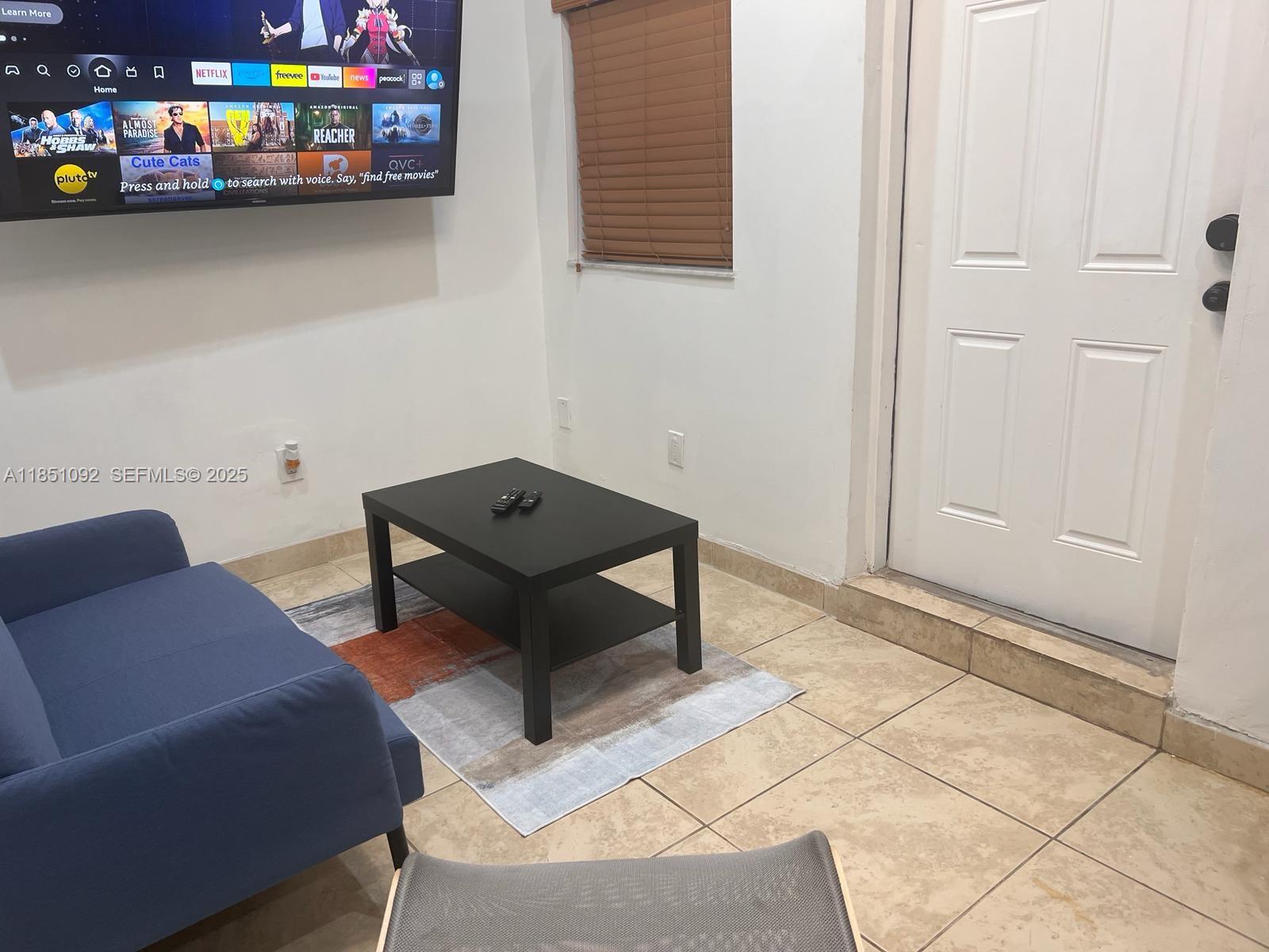 1721 Southwest 24th Terrace Miami, FL 33145 - Photo 63 of 80 a living room with furniture and a dining area with rug