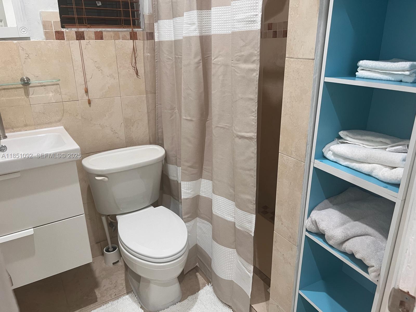 1721 Southwest 24th Terrace Miami, FL 33145 - Photo 69 of 80 a white toilet sitting next to a bathroom sink