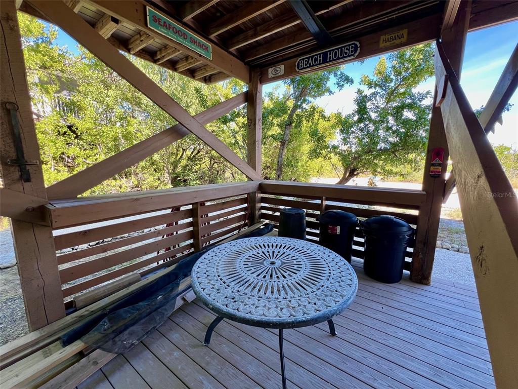 9568 Buccaneer Trail Boca Grande, FL 33921 - Photo 13 of 49 a view of a wooden deck with a bench