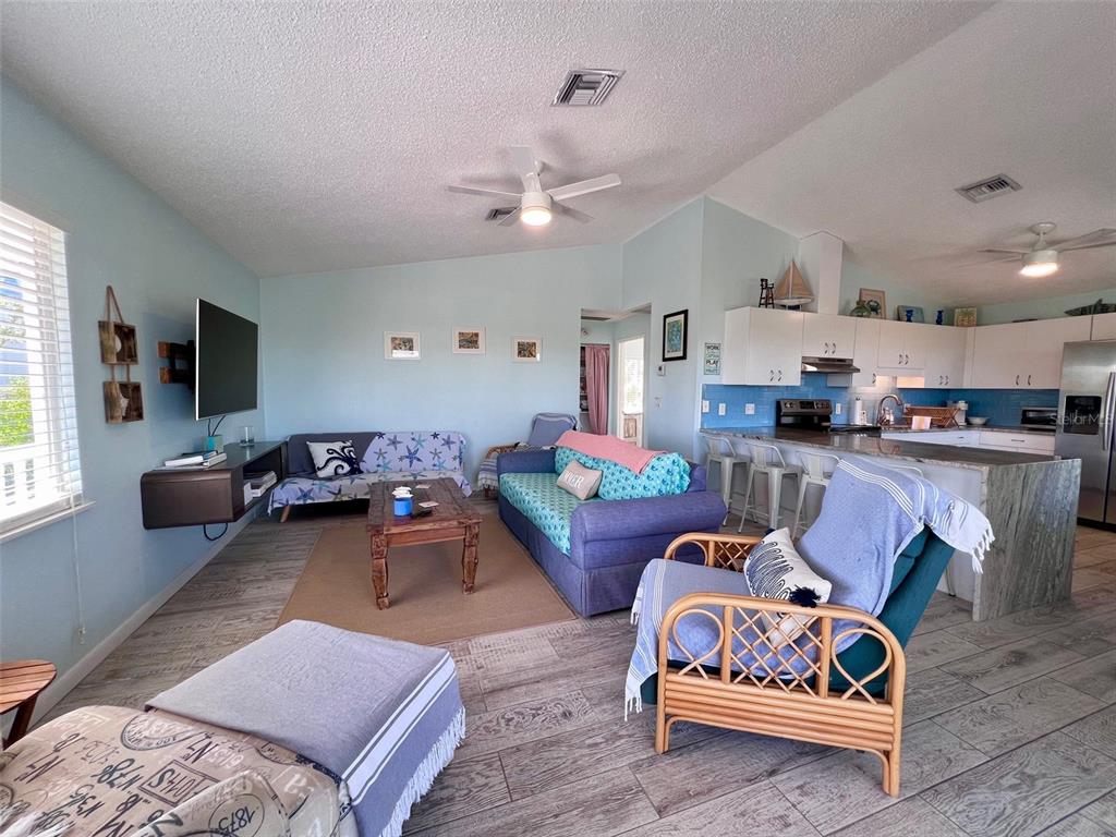 9568 Buccaneer Trail Boca Grande, FL 33921 - Photo 25 of 49 a living room with furniture and kitchen view