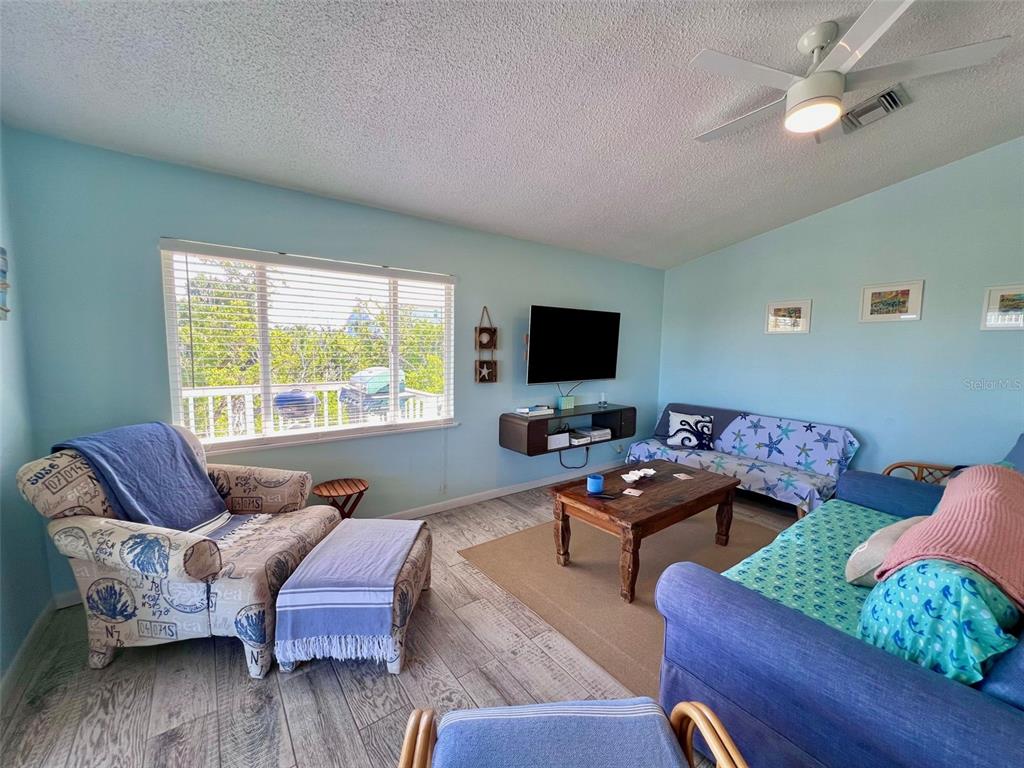 9568 Buccaneer Trail Boca Grande, FL 33921 - Photo 27 of 49 a living room with furniture and wooden floor
