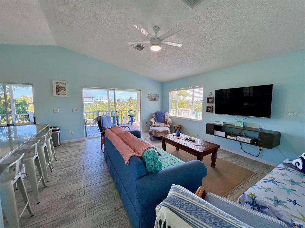9568 Buccaneer Trail Boca Grande, FL 33921 - Photo 28 of 49 a living room with furniture and a flat screen tv