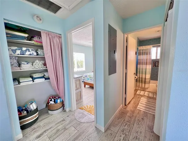 a bedroom with a bed chandelier and a window