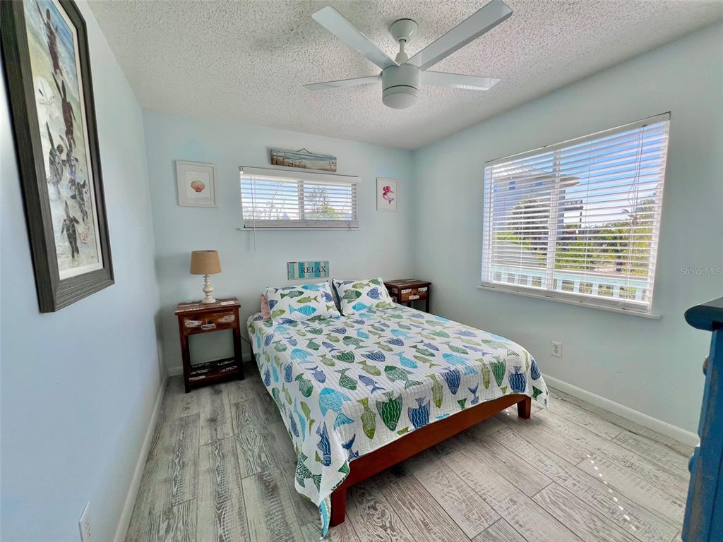 9568 Buccaneer Trail Boca Grande, FL 33921 - Photo 35 of 49 a bedroom with a bed chandelier and a window