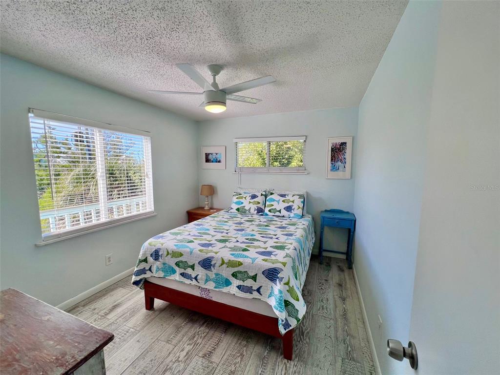 9568 Buccaneer Trail Boca Grande, FL 33921 - Photo 37 of 49 a bedroom with a bed and a table