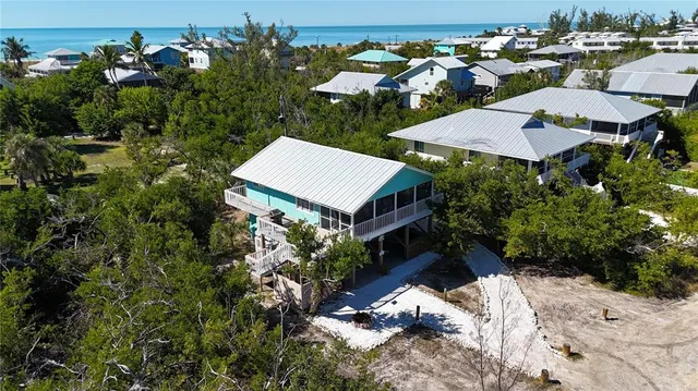 an aerial view of a house with a yard and lake view